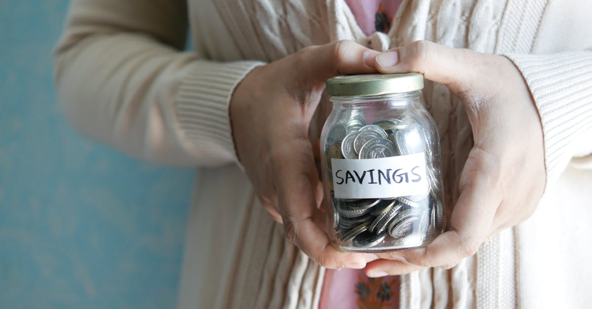 Jar filling with coins representing monthly savings