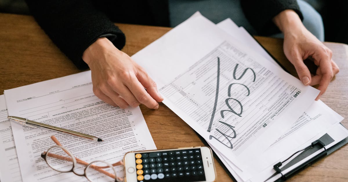 Freelancer at desk with tax forms and calculator